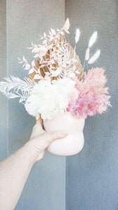 Pink and white dried flowers with a palm in a pot- Noosa