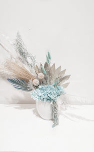 Teal detailed dried floral arrangement in a pot