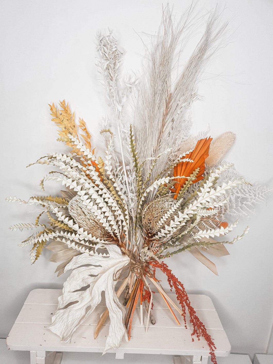 Watch the sunset, bright orange floral arrangement with Australian natives.