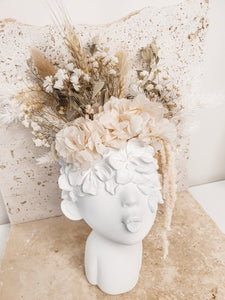 Minimal lady face planter and dried florals.