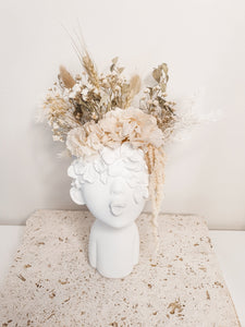 Minimal lady face planter and dried florals.