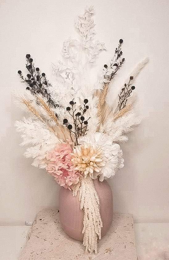 Pink and black potted everlasting flower arrangement.- pretty wanderer